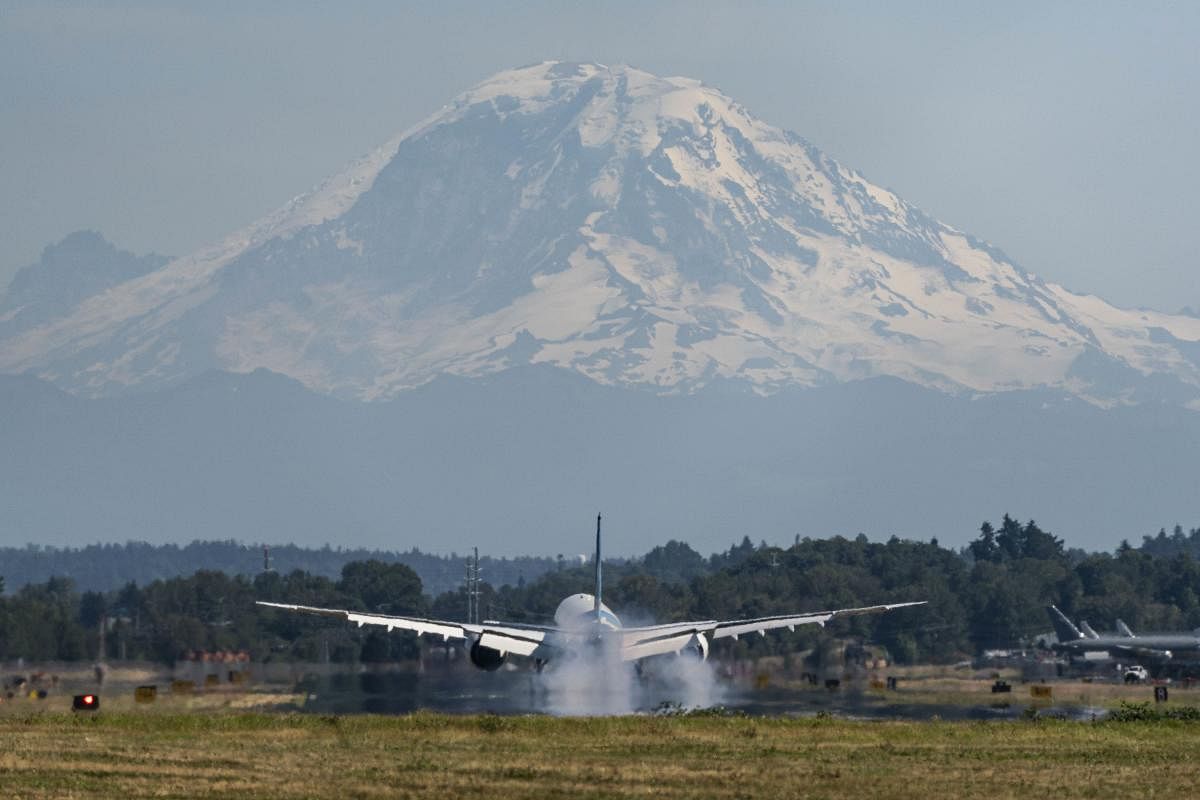 The all-new Zoom 777X airliner lands at Boeing Field, with Mount Rainier seen in the background, on July 28, 2020 in Seattle, Washington.. Credit: AFP