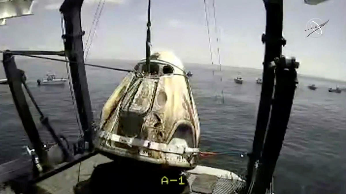 A capsule with NASA astronauts Robert Behnken and Douglas Hurley is lifted out of water in the Gulf of Mexico, August 2, 2020, in this still image taken from a video. Credit: NASA/Handout via REUTERS