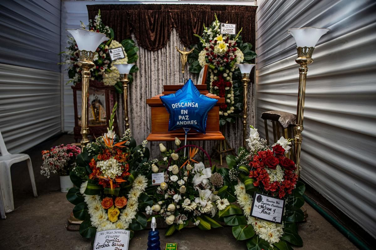 The coffin of a suspected Covid-19 victim is being veiled next to a graveyard in Comas, in the northern outskirts of Lima. Credit: AFP