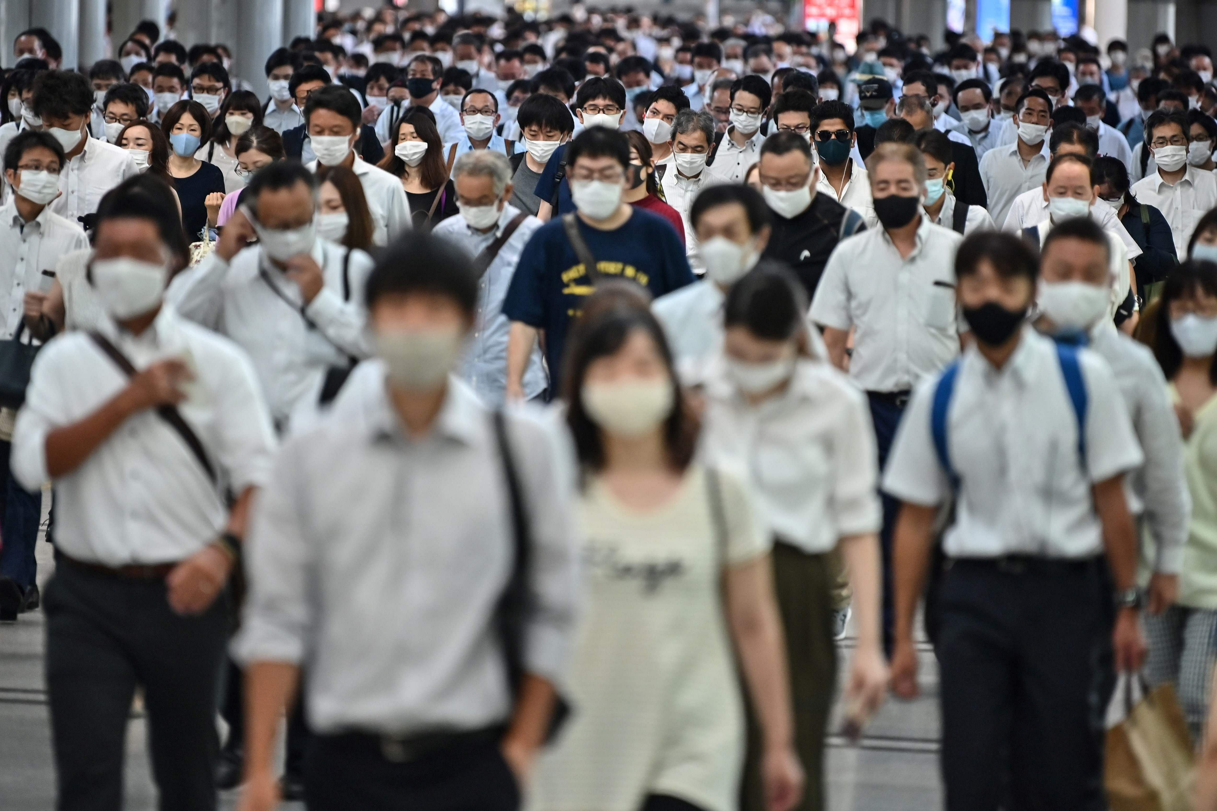 People commute early morning in Tokyo. Credits: AFP Photo