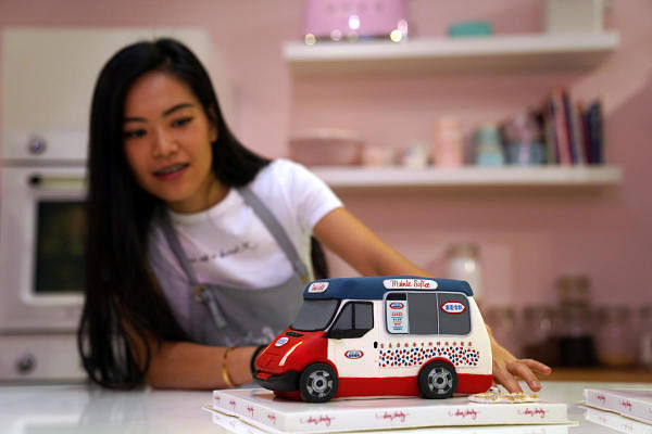 Alison, co-owner of Dear Harley Cake Studio, shows one of the illusion cakes, imitating a local mobile ice cream truck at the studio in Hong Kong, China. Credit: Reuters Photo