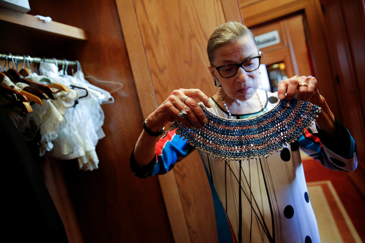 US Supreme Court Justice Ruth Bader Ginsburg shows the many different collars (jabots) she wears with her robes, in her chambers at the Supreme Court building in Washington, US. Credit: Reuters Photo