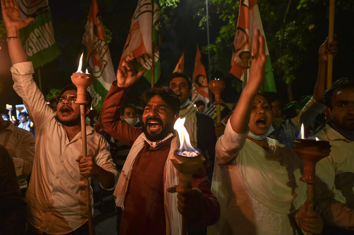 Indian Youth Congress (IYC) activists participate in a torch procession during a protest against farmers' bills, in New Delhi. Credit: PTI Photo