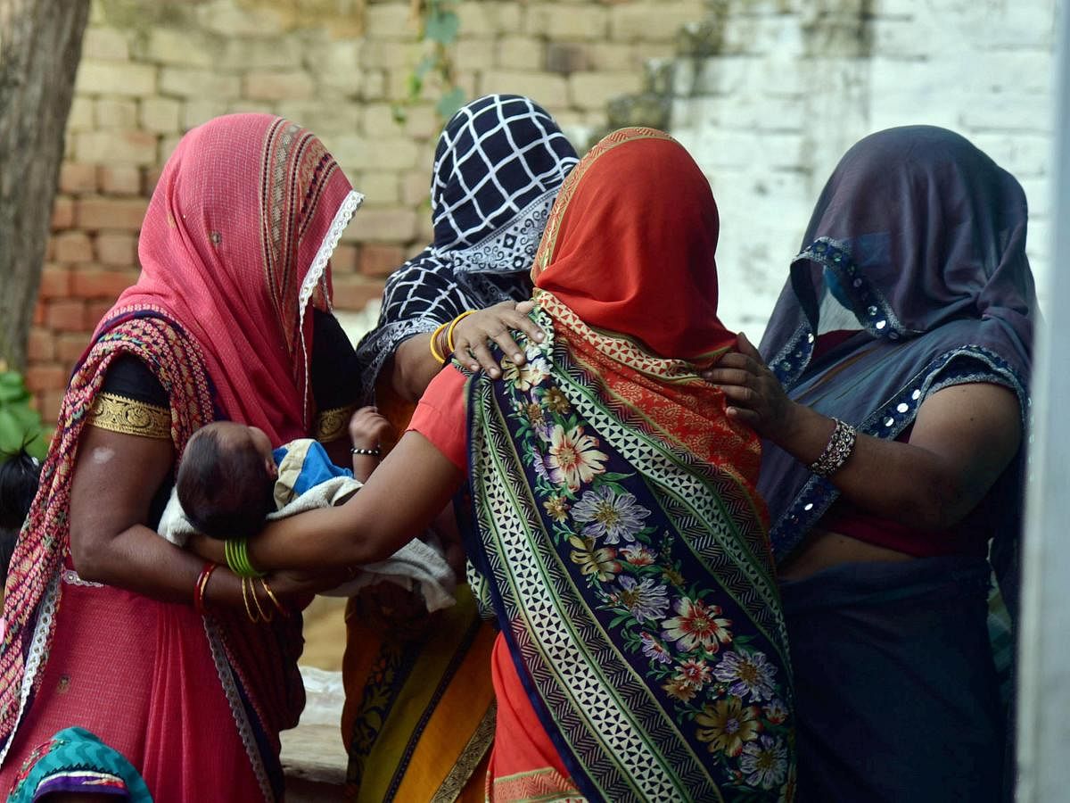 Family members and relatives mourn the death of a 19-year-old woman, who was gang-raped two weeks ago, in Hathras, Uttar Pradesh. The Dalit teen died at a hospital in Delhi on Tuesday morning. Credit: PTI Photo