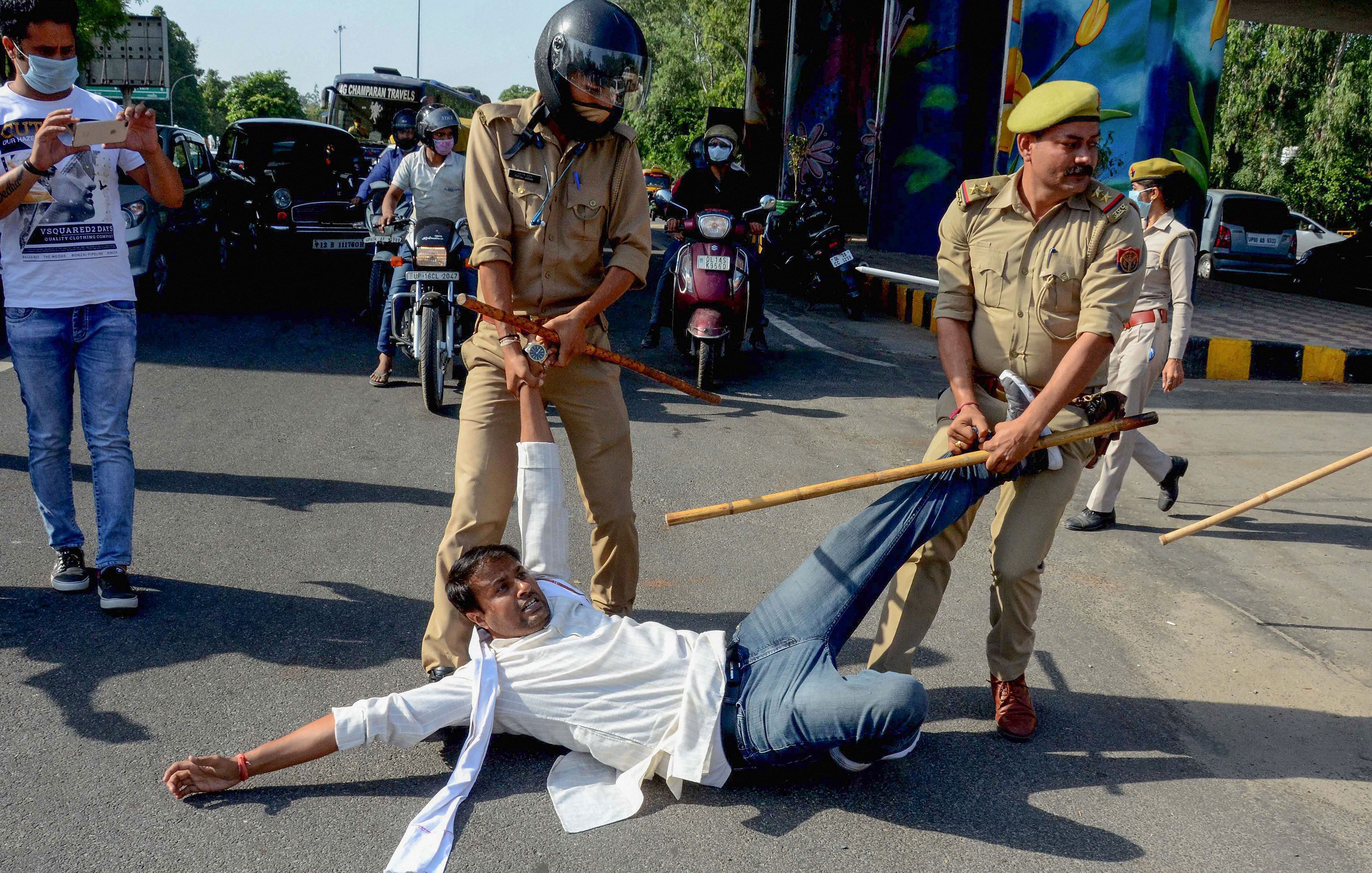 Police personnel lathi-charge on Congress workers protesting over the death of Hathras gang-rape victim, in Noida. Credit: PTI