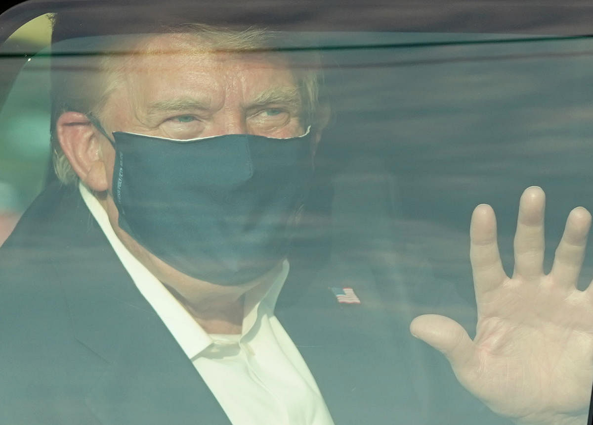 US President Donald Trump drove past supporters outside the hospital where he was being treated for Covid-19, after announcing on Twitter a "surprise visit" to his backers. Credit: AFP Photo