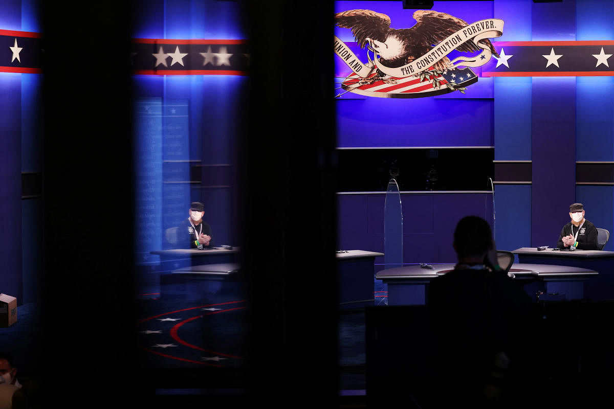 Stand-ins for the candidates sit between freshly installed protective plexiglass panels put in place as a coronavirus disease precaution between the candidates seats for the October 7, 2020 vice presidential debate between Vice President Mike Pence and Democratic vice presidential nominee and US Senator Kamala Harris on the campus of the University of Utah in Salt Lake City. Credit: Reuters Photo