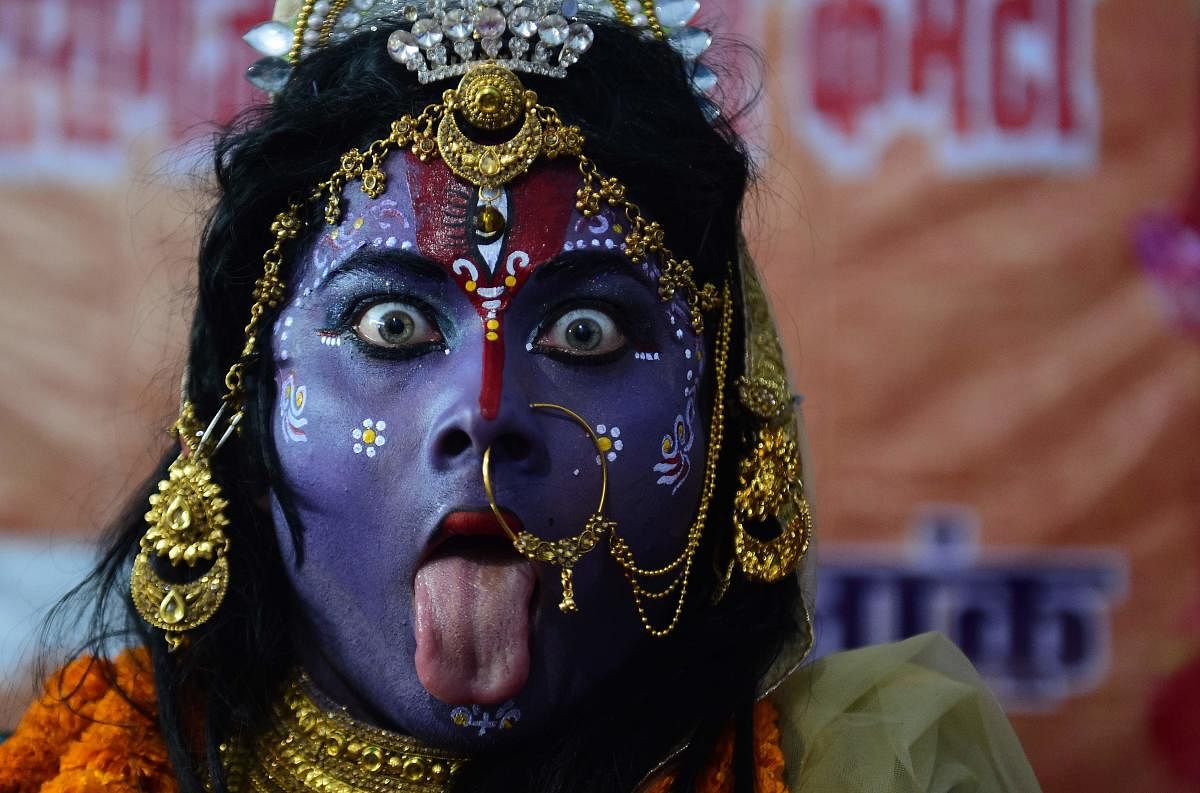 An artist dressed as the Hindu Goddess Kali performs a traditional dance during the Navaratri (nine nights) festival celebrations in Allahabad. Credit: AFP Photo
