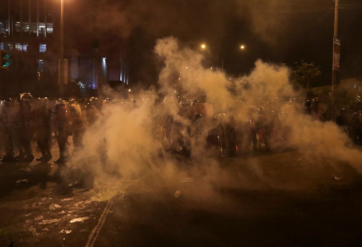 Police are seen amidst tear gas during protests following the impeachment of President Martin Vizcarra, in Lima, Peru. Credit: Reuters Photo
