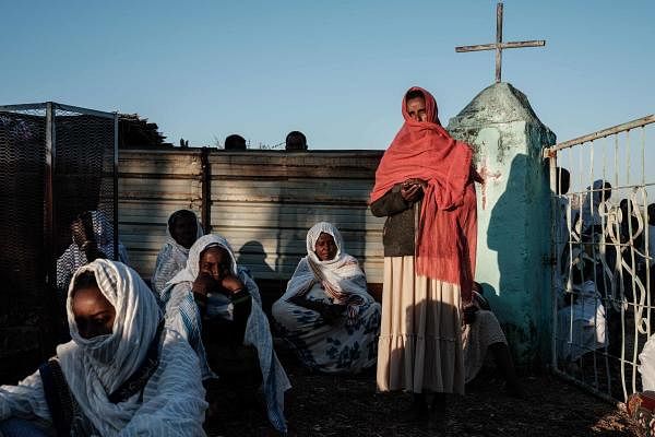 Ethiopian refugees who fled the Tigray conflict attend Sunday Mass with local believers, at an Ethiopian Orthodox church building built by former Ethiopian refugees, at the village next to Um Raquba refugee camp in Gedaref, eastern Sudan. Credit: AFP