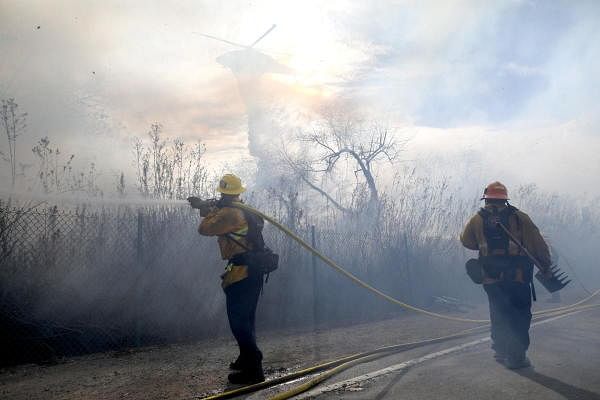 Firefighters tackle a blaze at a homeless encampment in Montebello, California, US. Credit: Reuters