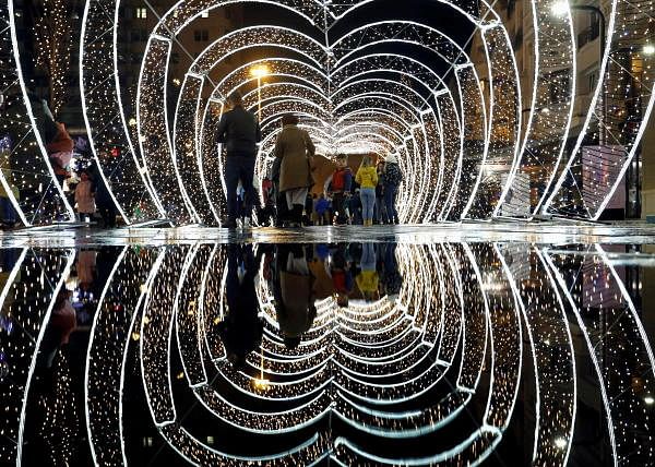 People walk past decorations and lights placed ahead of the New Year and Christmas season in Skopje, North Macedonia. Credit: Reuters