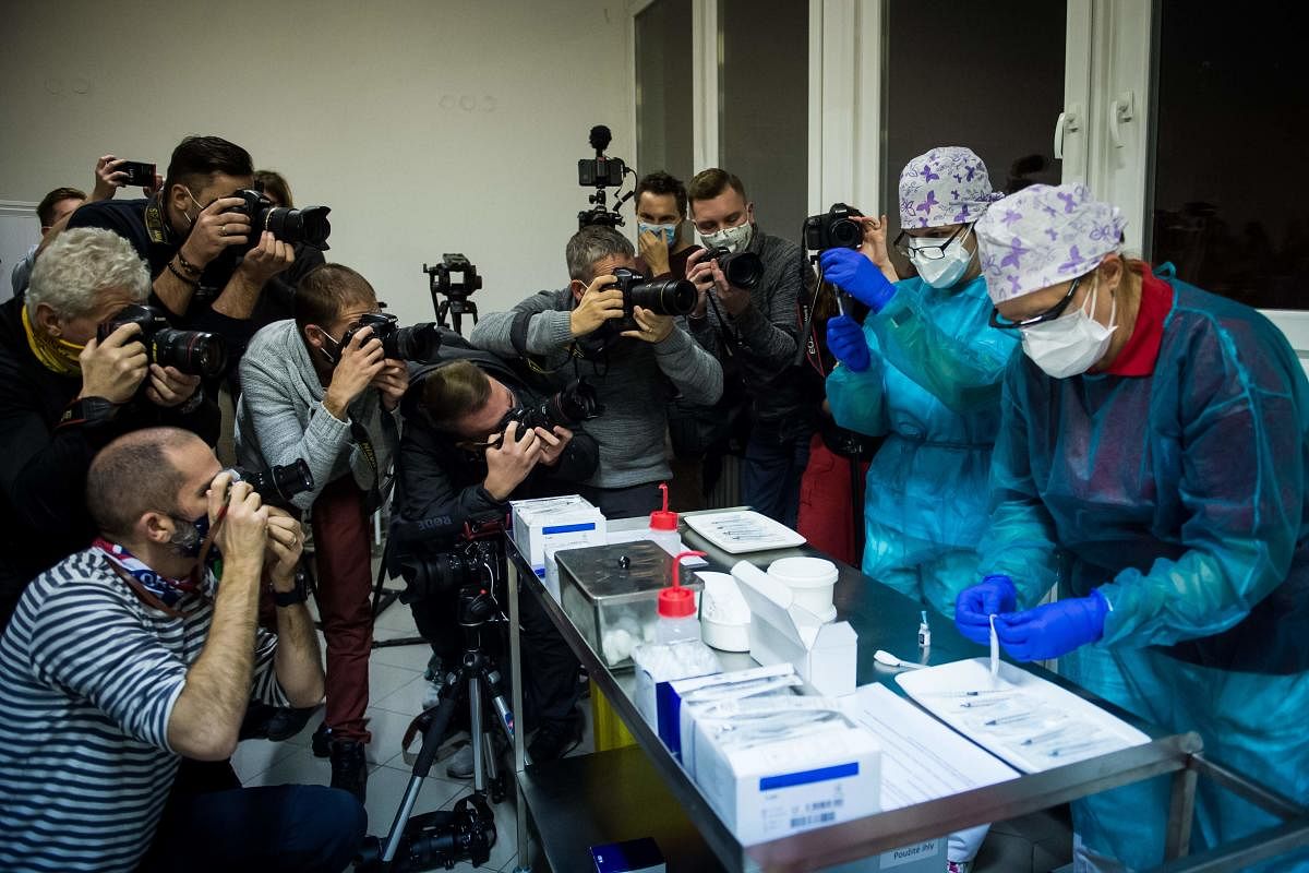 Medias are seen as a medic prepares a vaccine against Covid-19 as first people receive a vaccination the faculty hospital in Nitra, western Slovakia. Credit: AFP