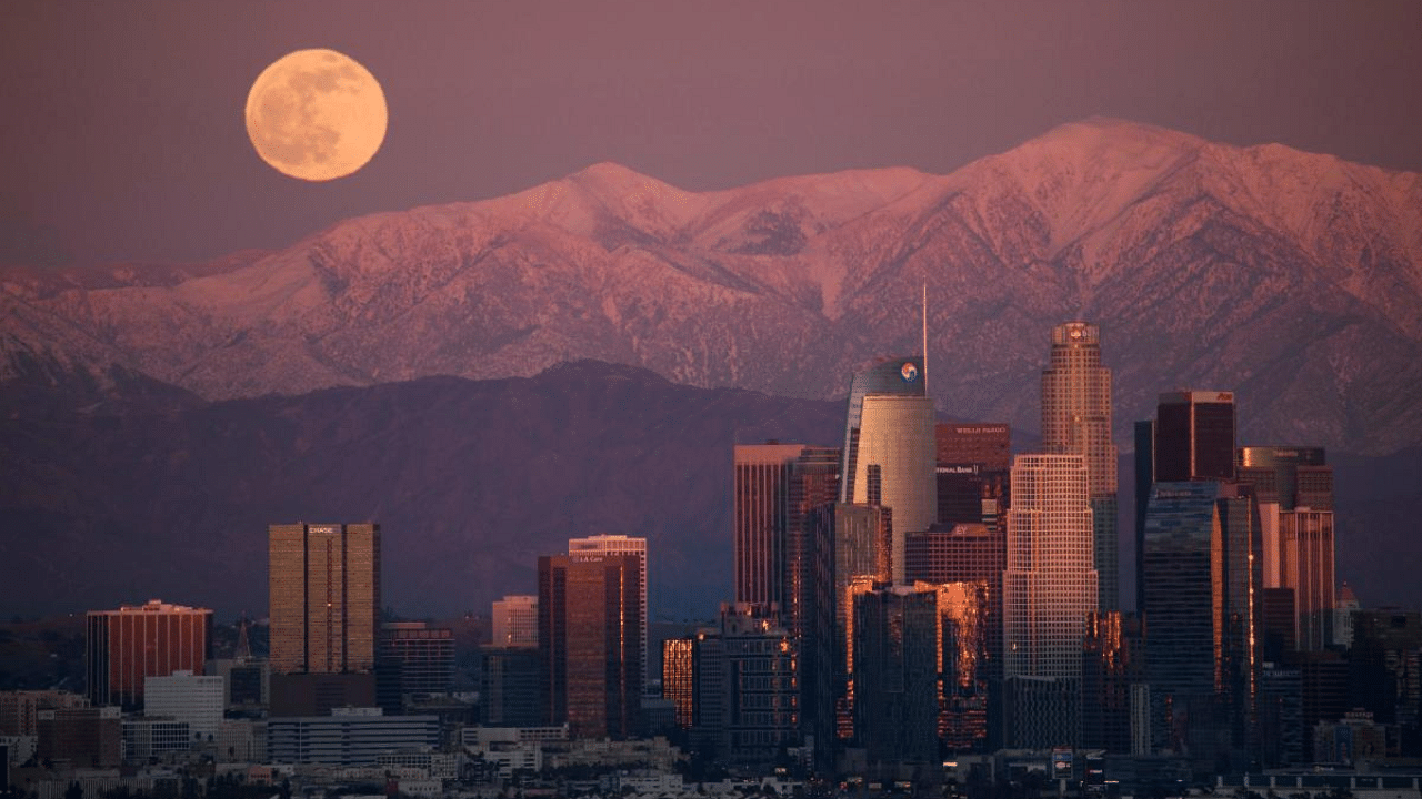 The last full moon of 2020, also known as the Cold Moon, rises behind the snow-topped San Gabriel Mountains and the Los Angeles downtown skyline at sunset as seen from the Kenneth Hahn State Recreation Area. Credit: AFP