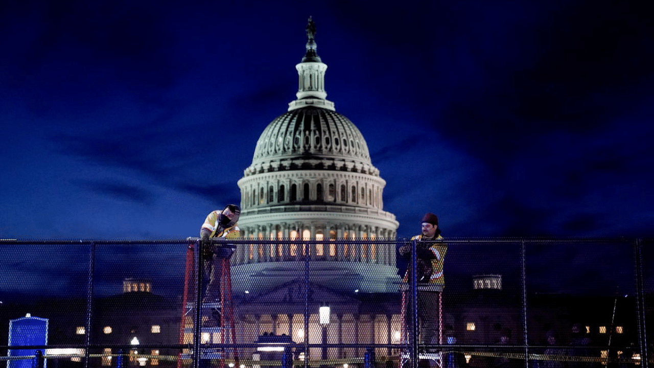 Workers install heavy-duty security fencing around the US Capitol a day after supporters of US President Donald Trump stormed the Capitol in Washington, US. Credit: Reuters Photo