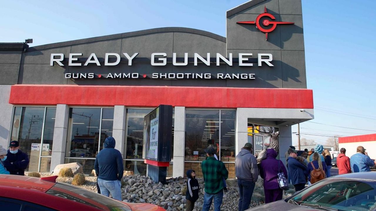 People line up to buy guns and ammunition at the Ready Gunner gun store on January 10, 2021 in Orem, Utah. - Ammunition and guns sales have spiked in Utah in the days since the storming of the Capitol building in Washington DC. Credit: AFP.