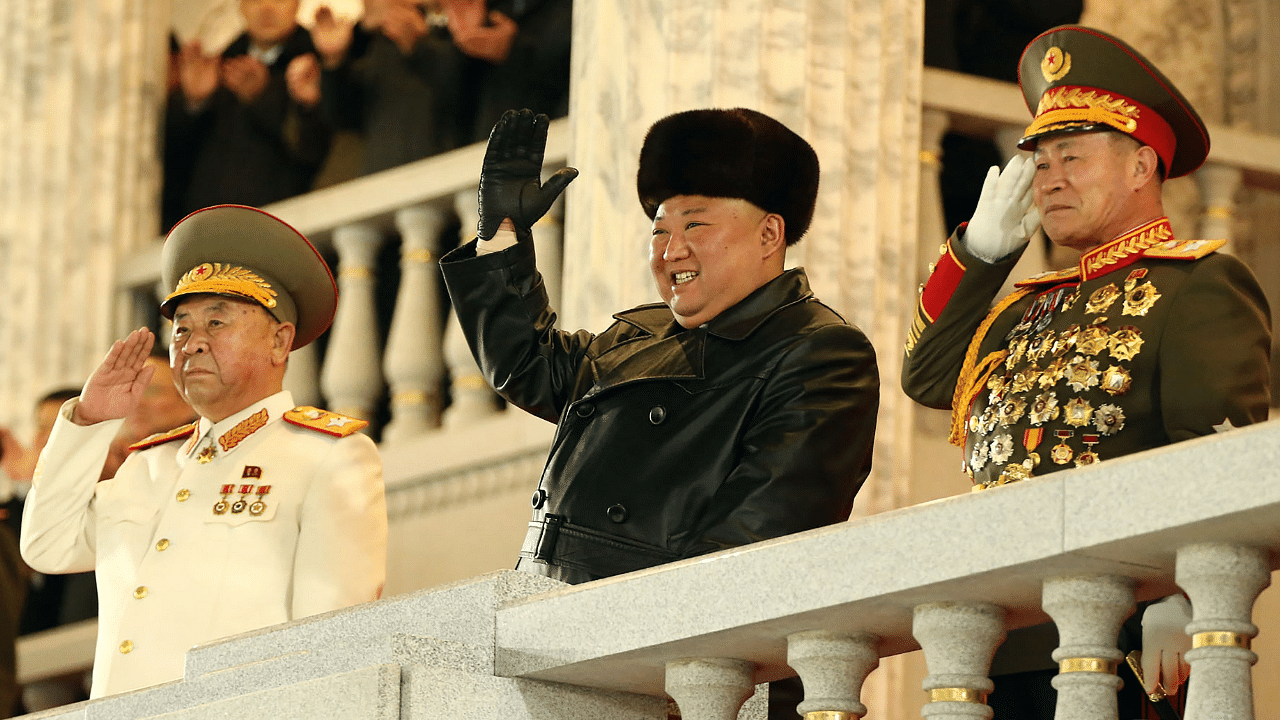 North Korean leader Kim Jong Un (C) gestures from the tribune during a military parade celebrating the 8th Congress of the Workers' Party of Korea (WPK) in Pyongyang. Credit: AFP/KCNA Photo