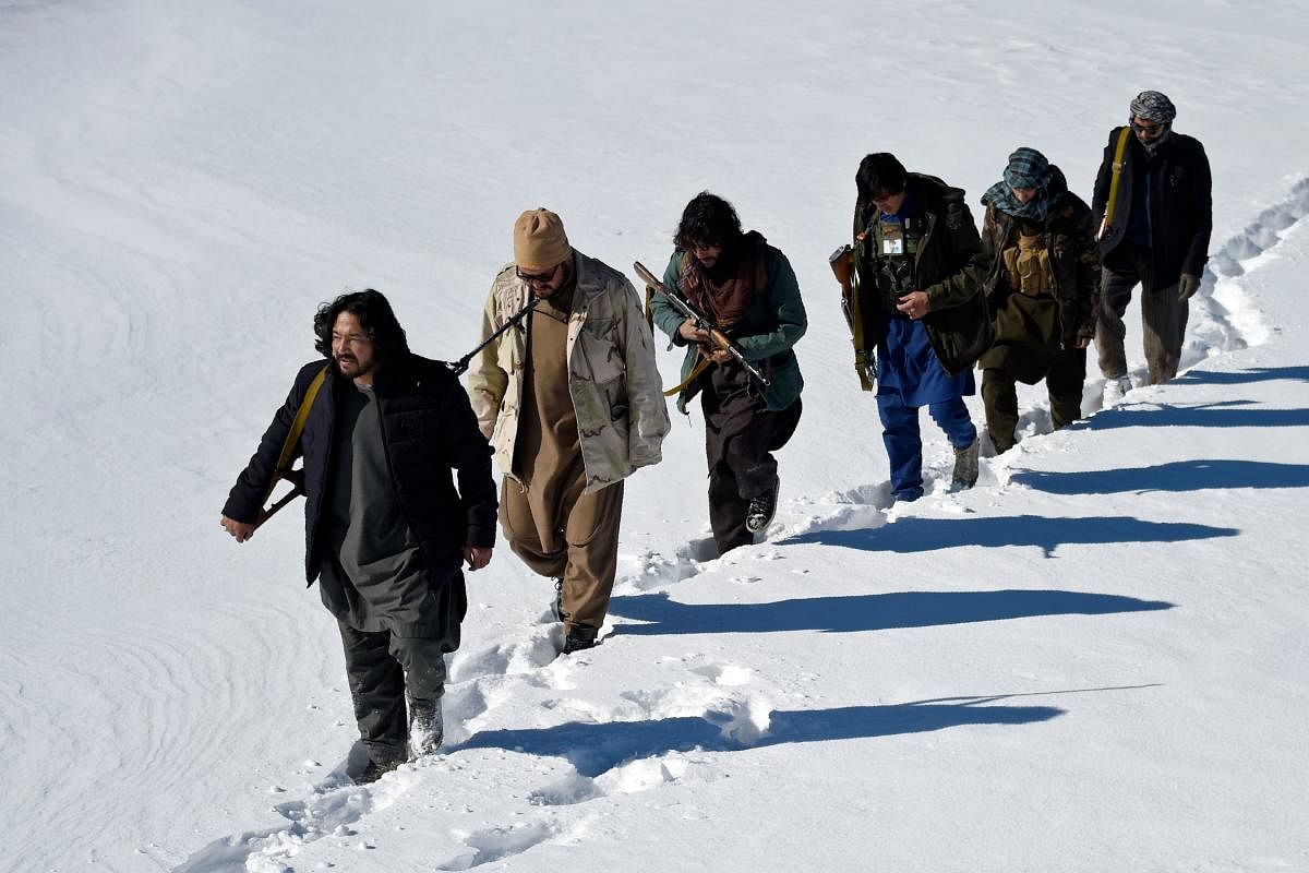  Hazara armed militia for the Resistance for Justice Movement, walk on a snow-covered path during a patrol against Taliban insurgents at Hisa-e-Awali Behsud district of Maidan Wardak Province. Credit: AFP photo. 