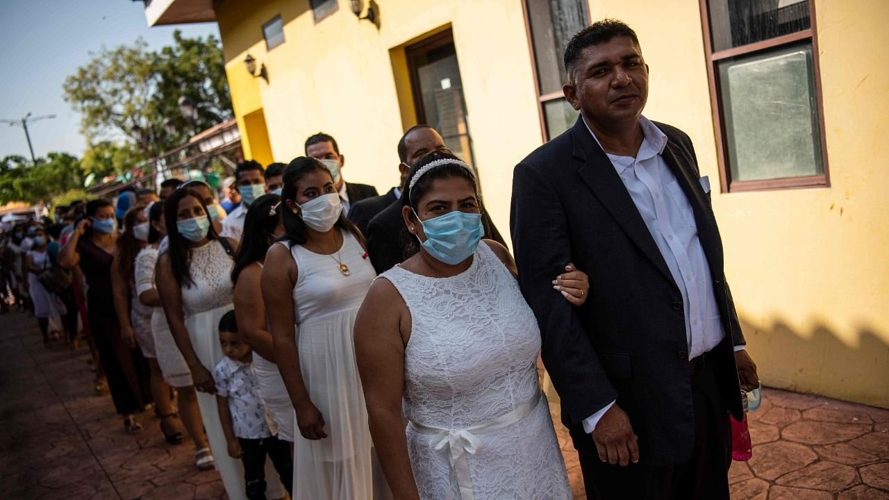 Couples line up before they get married in a mass wedding on Valentine's Day, at Paseo Xolotlan Park in Managua, Nicaragua. Credit: AFP Photo.