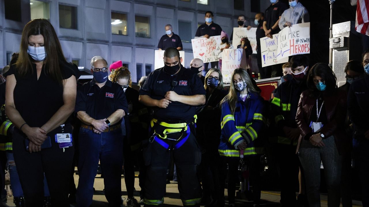 Firefighters, medical workers, first responders and members of the public gather in front of Northern Westchester Hospital to show support for the hospital and to mark the one year anniversary of the first Covid-19 patient admission to the hospital in Mount Kisco, New York. Credit: AFP Photo