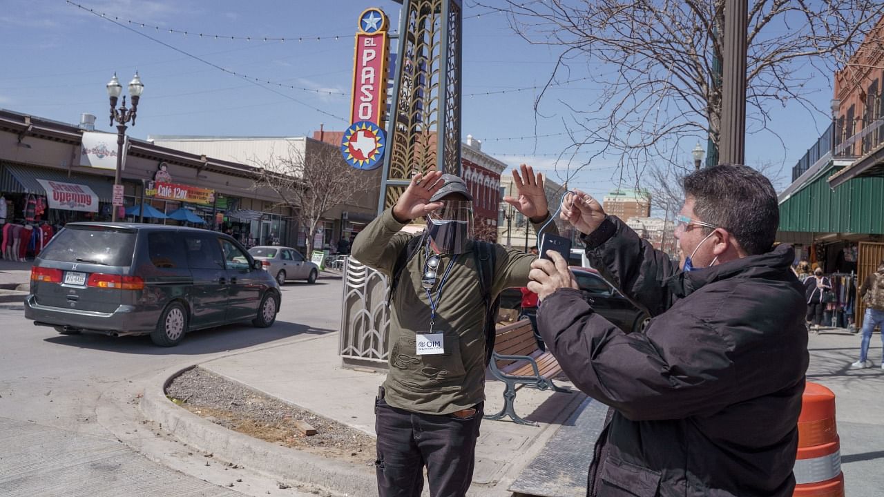 Mikel Aties, 42, (L) and Pedro Ruiz, 51, (R) both from Havana, Cuba, take pictures after entering the United States in downtown El Paso, Texas after waiting for two years in Migrant Protection Protocols (MPP), or the "Remain in Mexico Policy," in Ciudad Juarez, Mexico. Credit: AFP Photo