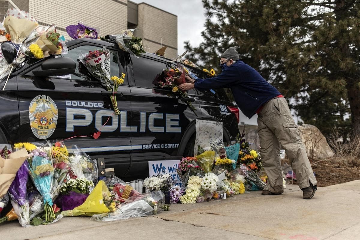 Mourners pay their respects to Officer Eric Talley, who was killed after a gunman opened fire at a King Sooper's grocery store on March 23, 2021 in Boulder, Colorado. Credit: AFP Photo