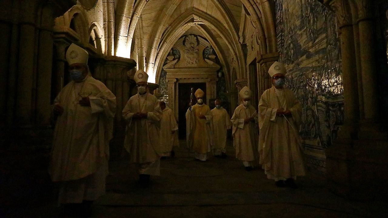 Members of the clergy attend the traditional Easter Vigil held in smaller numbers than in pre-pandemic years on the night of Holy Saturday, marking the ceremonial lighting of the Paschal candle the night before Easter Sunday, as the Covid-19 pandemic limitations on the number of people attending public gatherings remain in place, at the Se Cathedral in Porto, Portugal. Credit: Reuters Photo