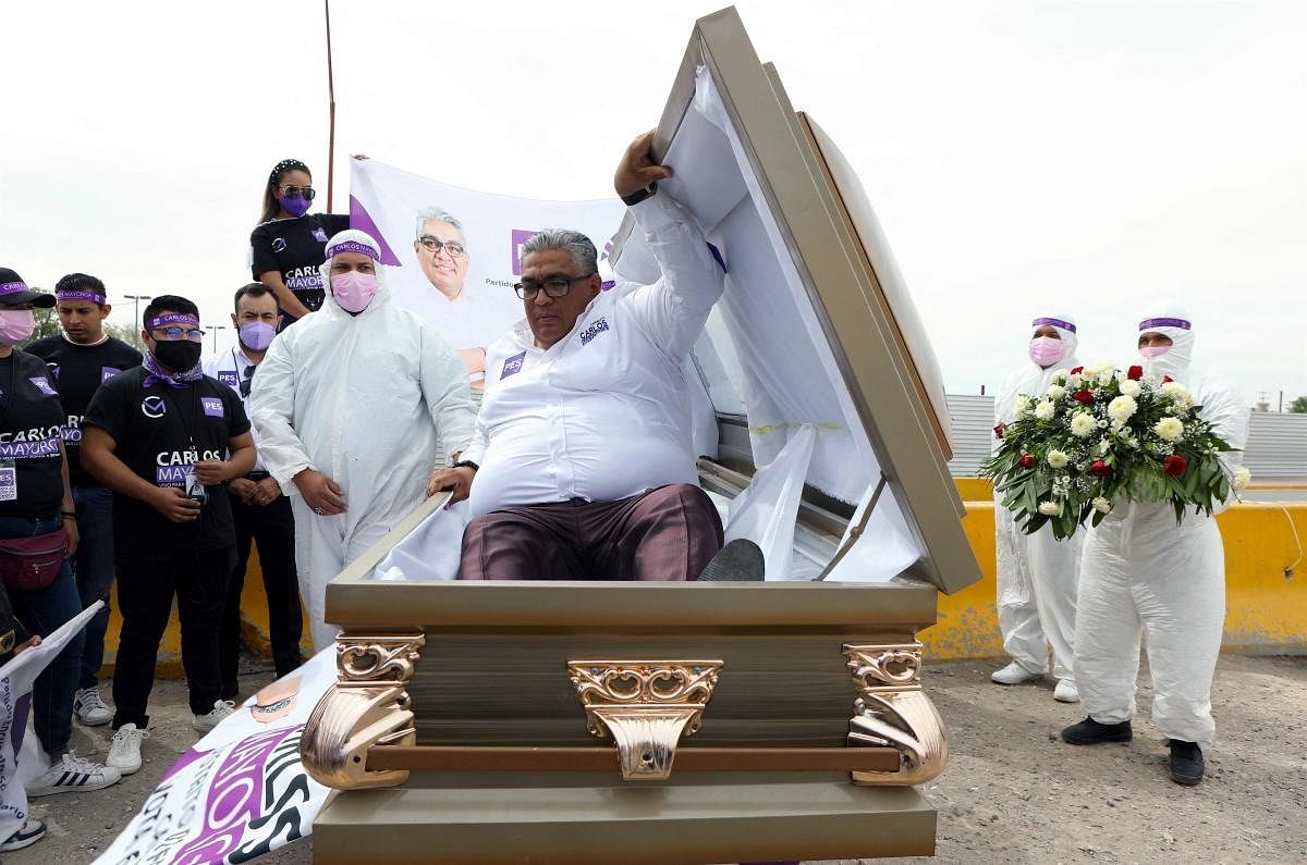 The Mexican candidate for federal deputy of the Social Encounter Party Carlos Mayorga launches his campaign inside a coffin, to highlight the country's many thousands of deaths from the coronavirus pandemic and cartel-related violence. Credit: AFP Photo