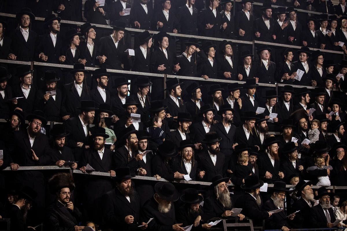 Ultra-Orthodox Jews sing and dance as they stand on tribunes at the Lag B'Omer event in Bnei Brak, near Tel Aviv, Israe. Credit: Reuters Photo