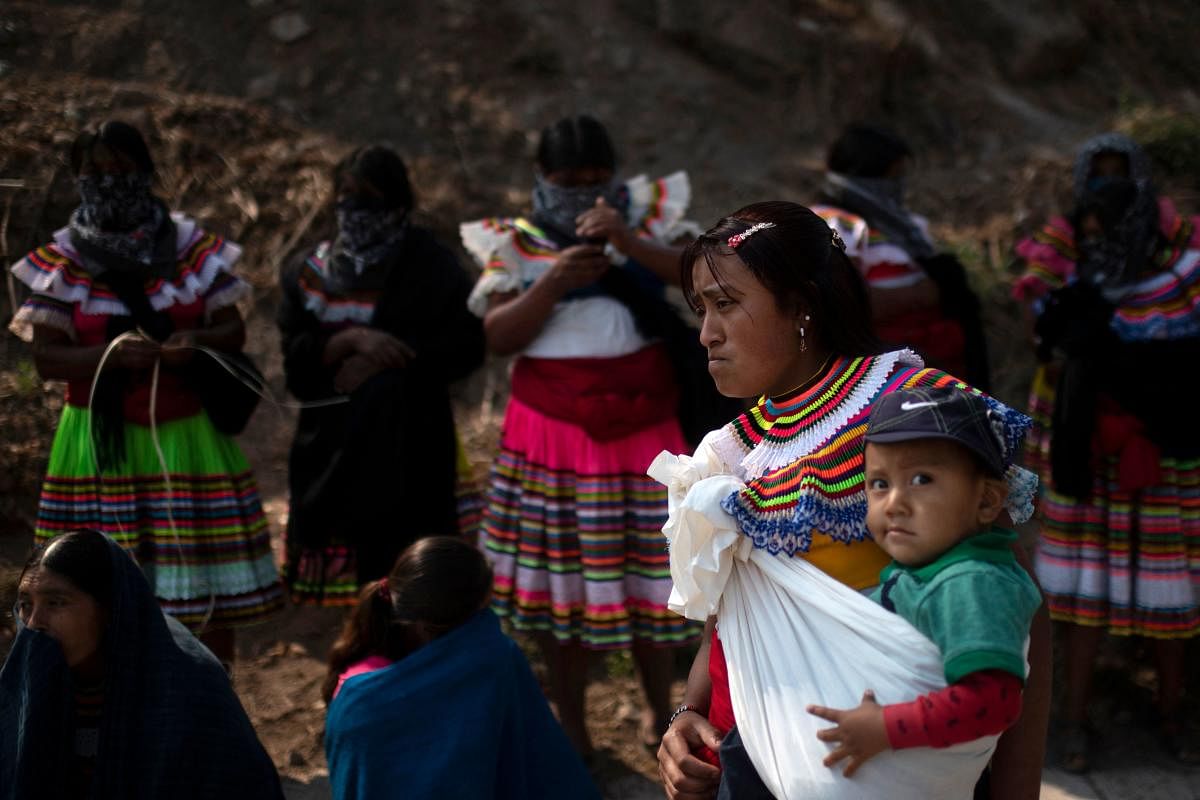 A woman in traditional attire and her toddler attend a demo for justice and the end of violence in the framework of the celebration of Children's Day in Alcozacan, Guerrero state, Mexico. Credit: AFP Photo