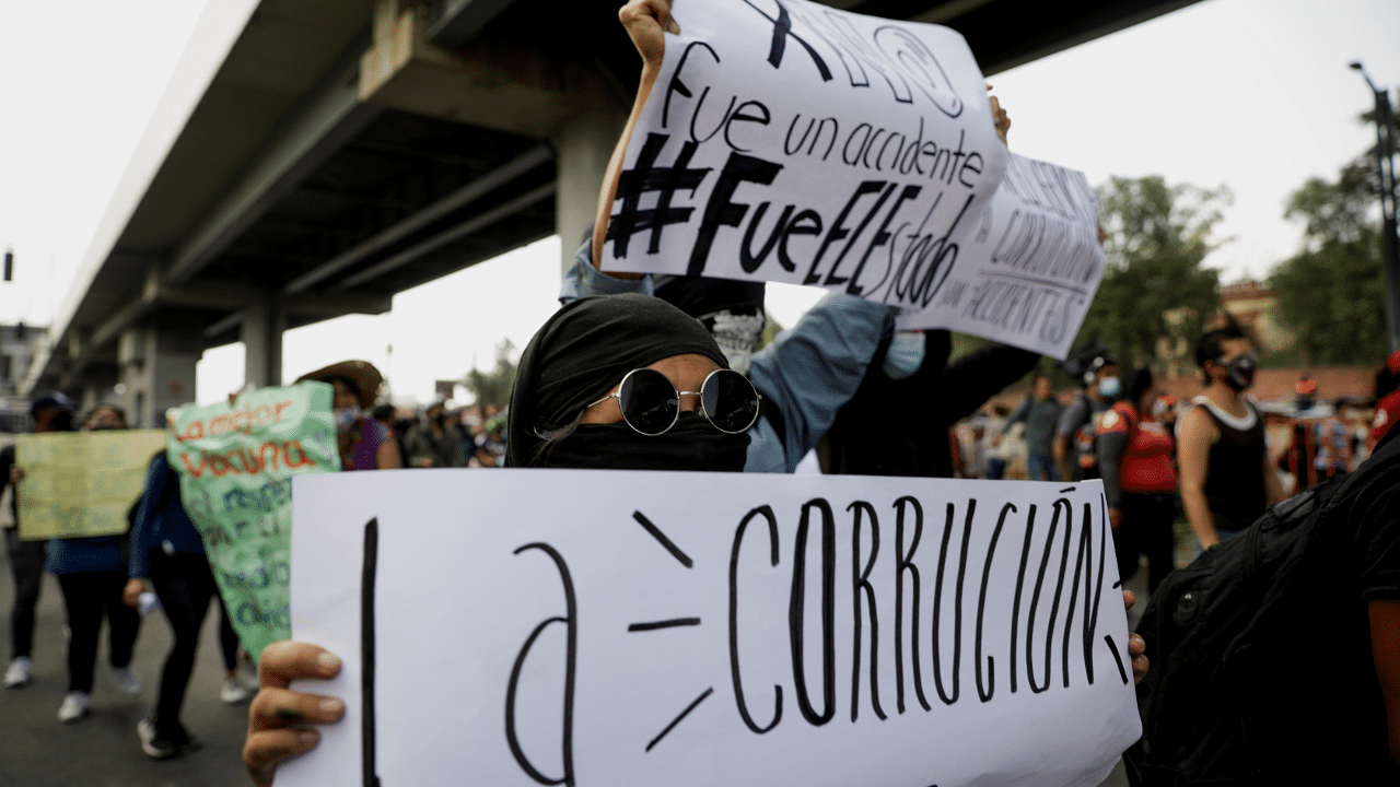 People take part in a march to protest against the government after an accident where an overpass of the metro partially collapsed with train cars on it, in Mexico City, Mexico. Credit: Reuters Photo