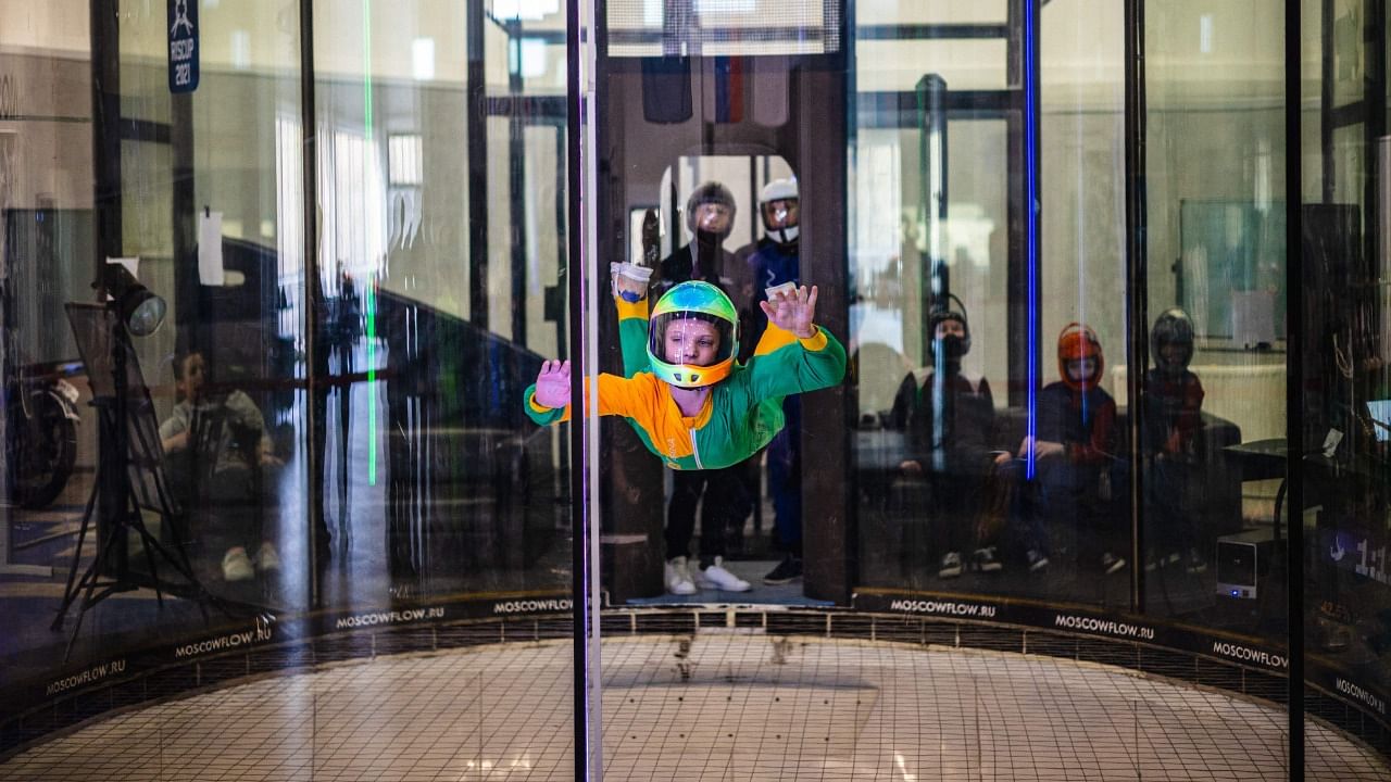 Marian Dolik, 13, who suffers from cerebral palsy, flies inside a vertical wind tunnel while competing in an indoor parachuting championship in Moscow. Credit: AFP Photo
