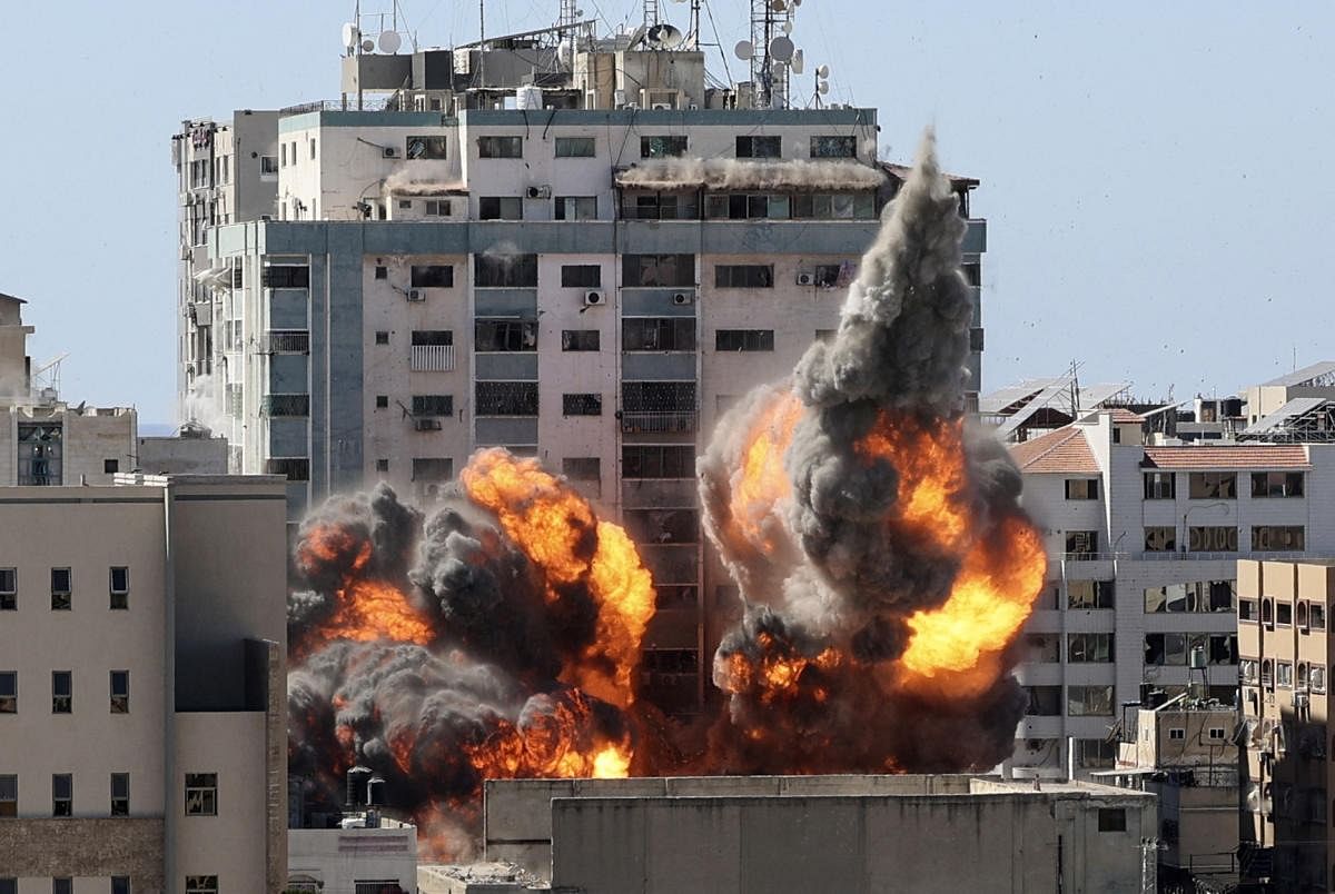 A ball of fire erupts from the Jala Tower as it is destroyed in an Israeli airstrike in Gaza city controlled by the Palestinian Hamas movement. Credit: AFP Photo