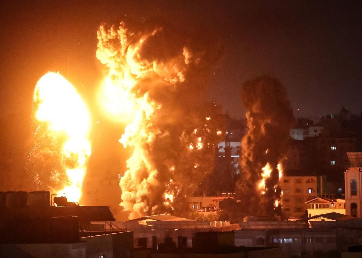 Fire and smoke rise above buildings in Gaza City as Israeli warplanes target the Palestinian enclave. Credit: AFP Photo