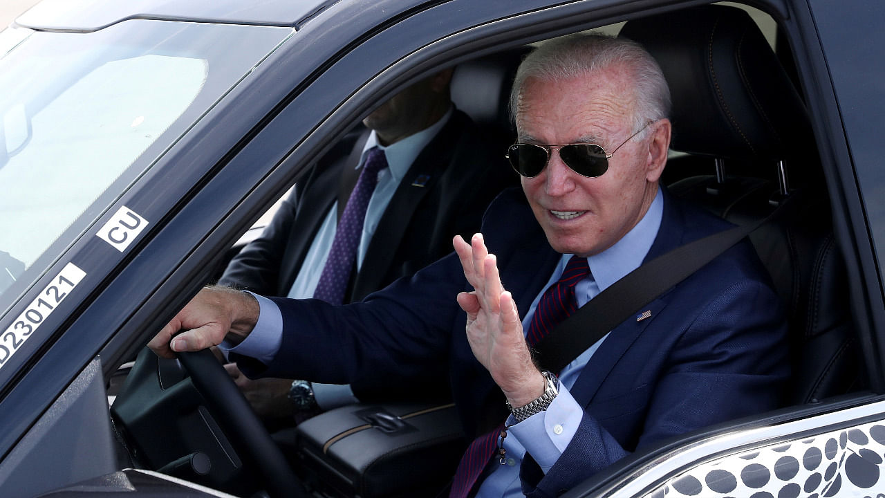 US President Joe Biden waves as he tests the new Ford F-150 lightning truck as he visits VDAB at Ford Dearborn Development Center in Dearborn, Michigan. Credit: Reuters Photo
