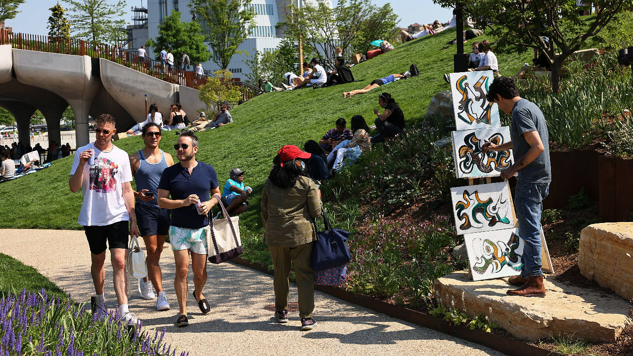 People enjoy the Little Island public park in Manhattan in New York City. The Little Island public park on 13th Street in Hudson River Park opened for the first time to the public today. The features 350 different flowers, trees and shrubs.Credit: AFP Photo