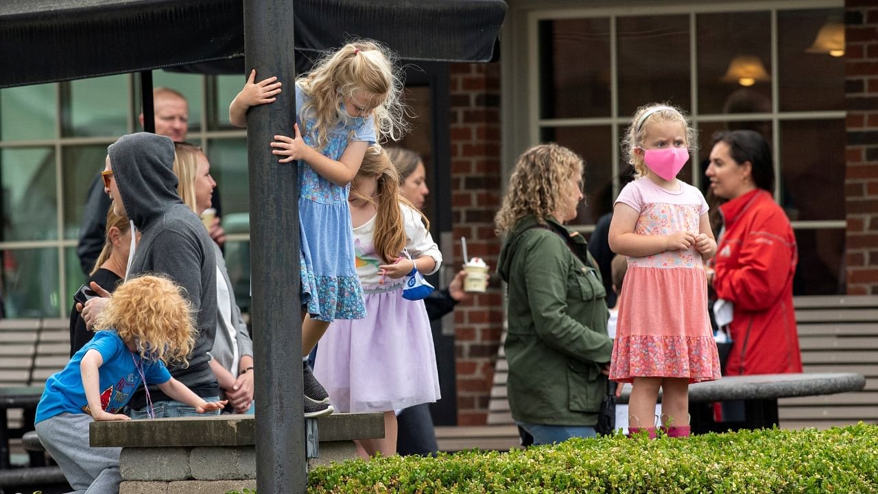 Kids wear face masks while adults remain unmasked at Johnson's Real Ice Cream as the coronavirus restrictions are lifted statewide in Columbus, Ohio. Credit: Reuters Photo