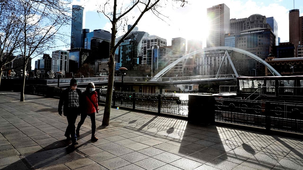 Face mask-clad pedestrians walk through Southbank in Melbourne following a fresh lockdown amid a resurgence in coronavirus cases. Credit: AFP Photo