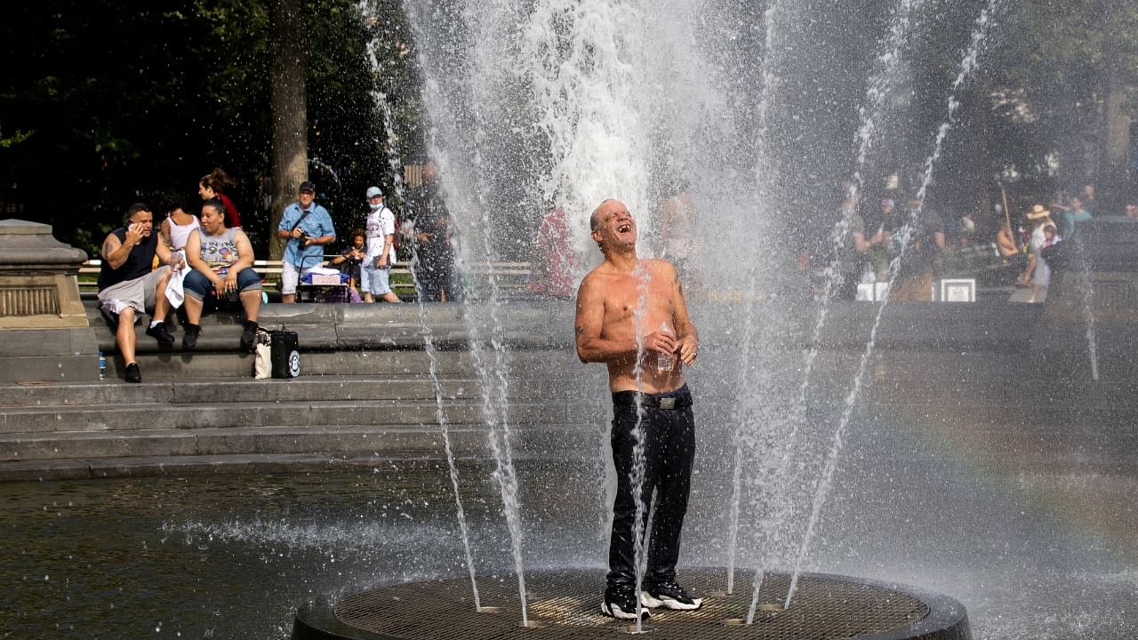 A man cools off himself on a fountain during a heat wave in New York City. Credit: Reuters Photo