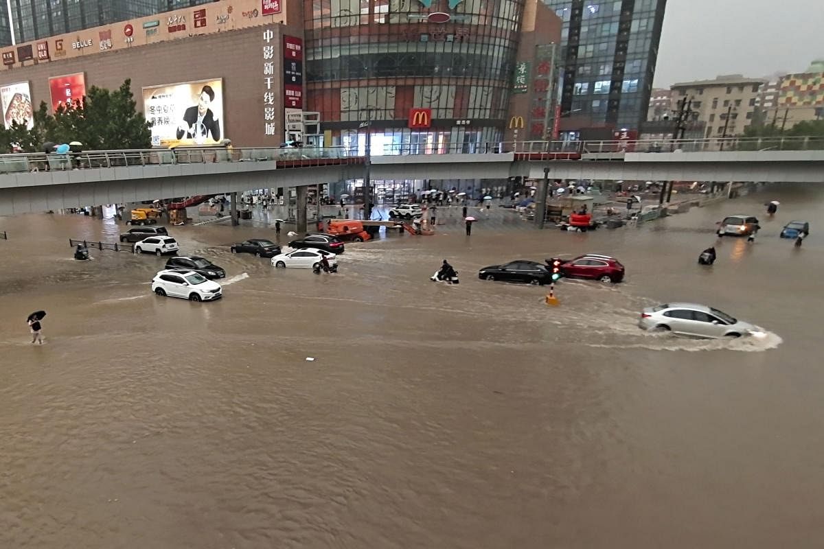 Vehicles are stranded after a heavy downpour in Zhengzhou city. Heavy flooding has hit central China following unusually heavy rains, with the subway system in the city of Zhengzhou inundated with water. Credit: AP Photo