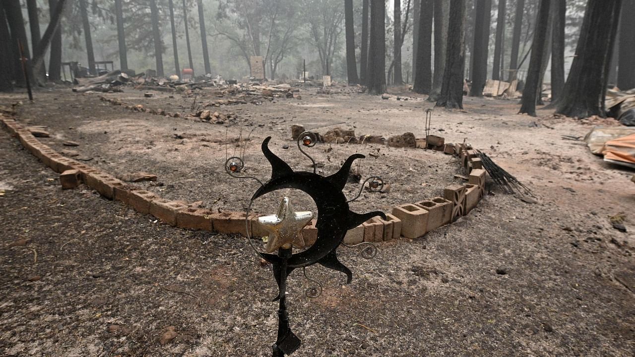 Homes and personal possessions burned in the Dixie Fire are still smoldering in the Indian Falls area of Plumas County, California. Credit: AFP Photo