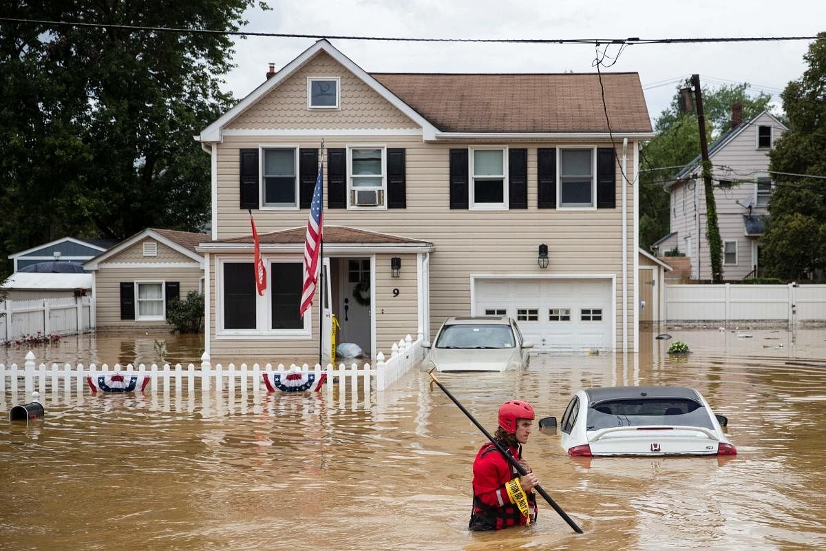 A New Market Volunteer Fire Company rescue crew member wades through high waters following a flash flood, as Tropical Storm Henri makes landfall, in Helmetta, New Jersey in US. Credit: AFP Photo