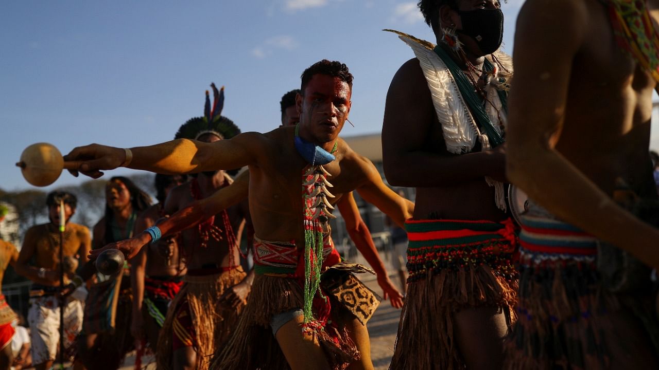 Indigenous people take part in a protest during the first day of Brazil's Supreme Court trial of a landmark case on indigenous land rights, in Brasilia. Credit: Reuters photo