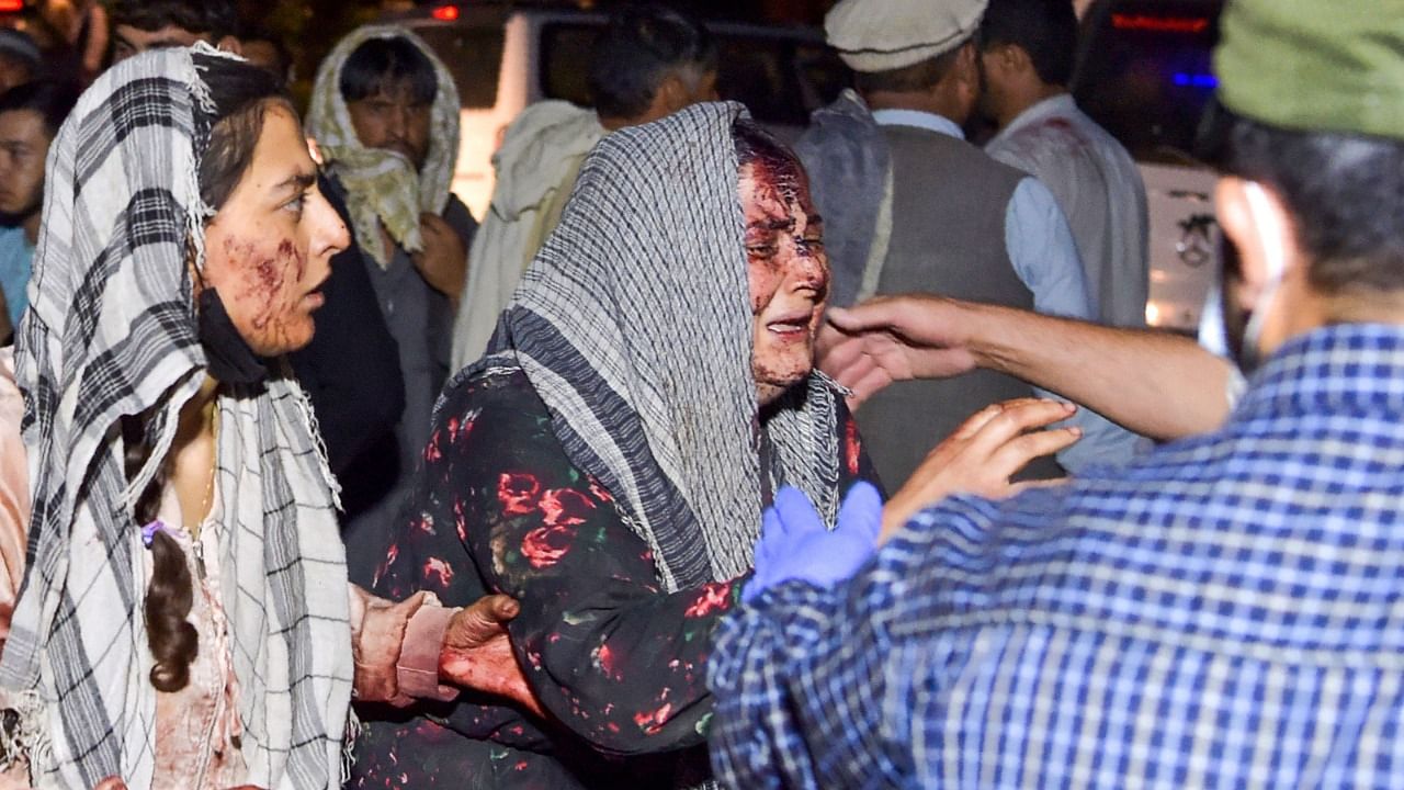 Desperation turns to grief as blast outside Kabul airport kills scores of Afghans