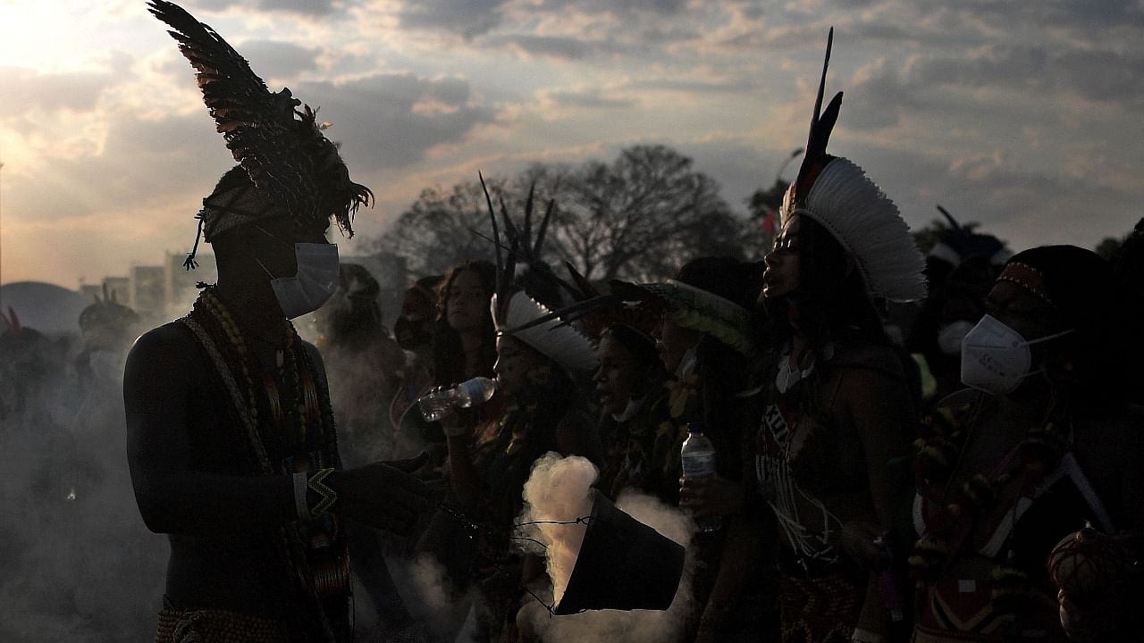 Indigenous people make a ritual as they protest outside the Supreme Court in Brasilia. Credit: AFP Photo