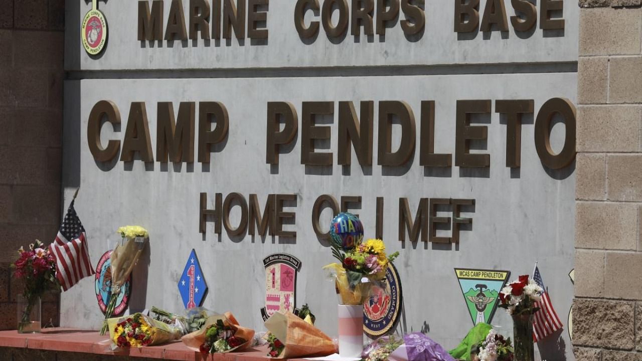 Flowers and other keepsakes adorn the entrance sign to Camp Pendleton on August 27, 2021 in Oceanside, California. Credit: AFP Photo