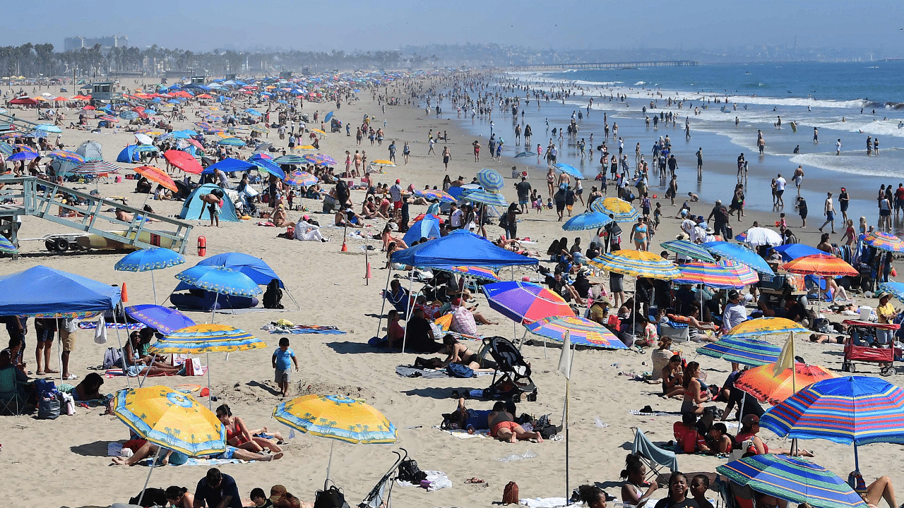 Umbrellas take over Santa Monica Beach as people head to the shoreline to beat the heat in Santa Monica, California as dry conditions and warm temperatures bring a heat advisory for Labor Day weekend. Credit: AFP Photo
