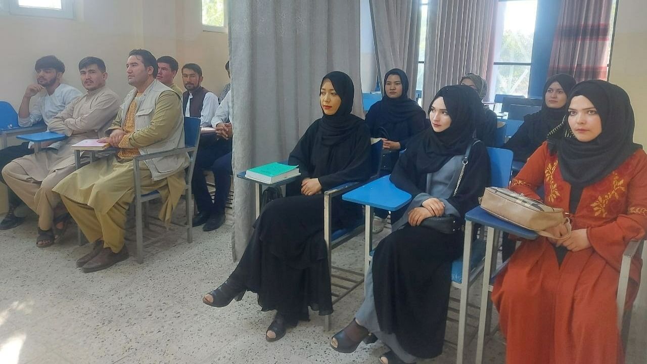 Female, male students separated by curtains in classroom as Afghan universities reopen under the Taliban Credit: Reuters Photo