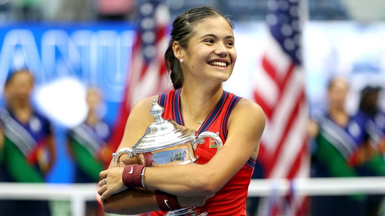 Emma Raducanu of Great Britain celebrates with the championship trophy after defeating Leylah Annie Fernandez of Canada during their US Open Women's Singles final. Credit: AFP Photo