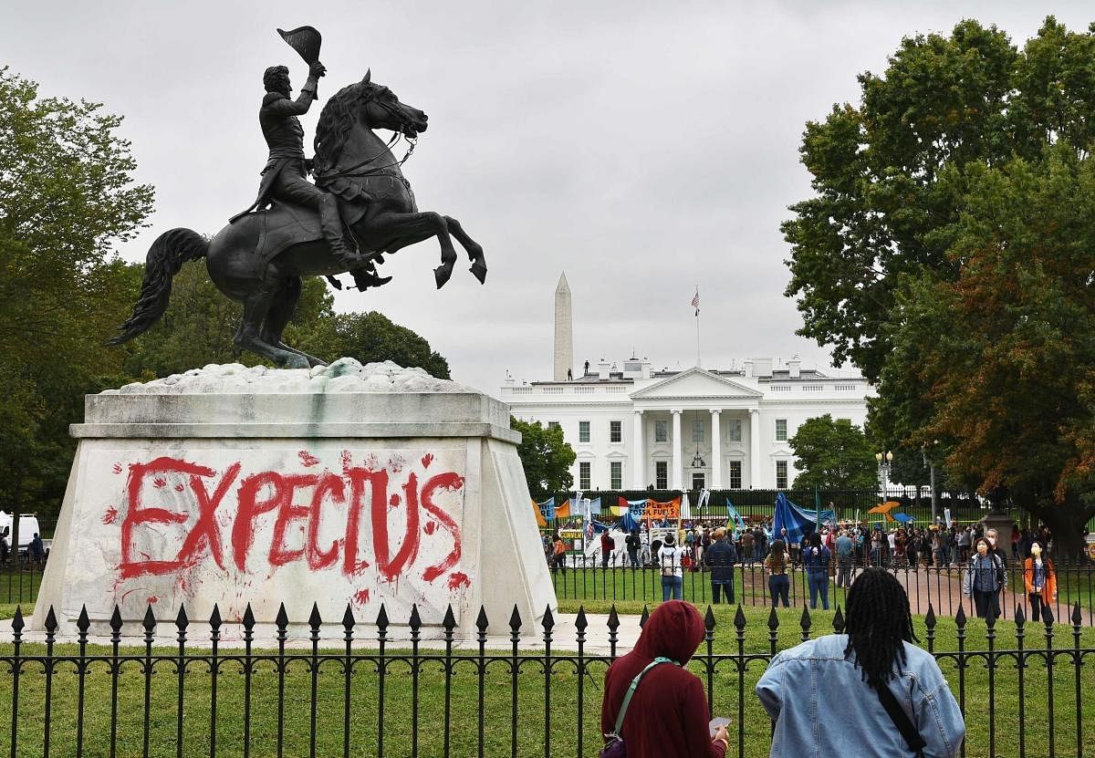 Graffiti reading "expect us" is seen on the base of the statue of US president Andrew Jackson at Lafayette Square in Washington, DC, as environmental and indigenous rights activists rally in front of the White House. Credit: AFP Photo